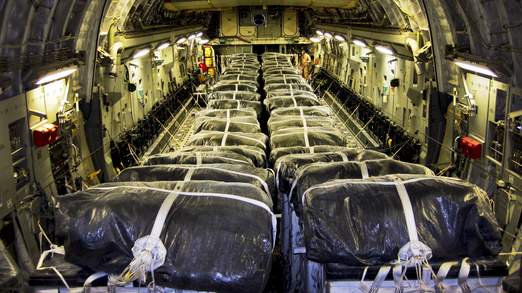 Water bundles align a C-17 Globemaster III cargo plane at Al Udeid Air Base, Qatar, prior to a humanitarian air drop over Iraq